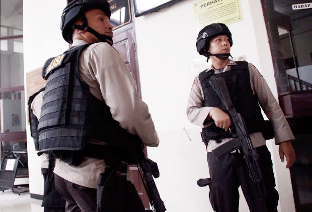 Polisi bersenjata lengkap berjaga di luar ruang sidang ketika terdakwa kasus terorisme Aman Abdurrahman menjalani persidangan vonis di Pengadilan Negeri Jakarta Selatan, 22 Juni 2018. (Arie Firdaus/BeritaBenar)