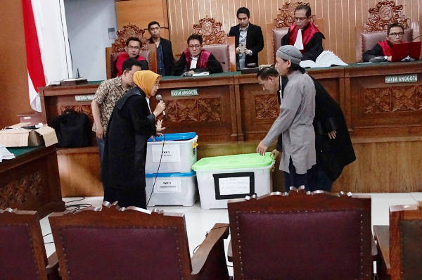 Jaksa memperlihatkan barang bukti kasus terorisme pada Aman Abdurrahman (kanan) dalam persidangan di Pengadilan Negeri Jakarta Selatan, 27 April 2018. (Arie Firdaus/BeritaBenar)