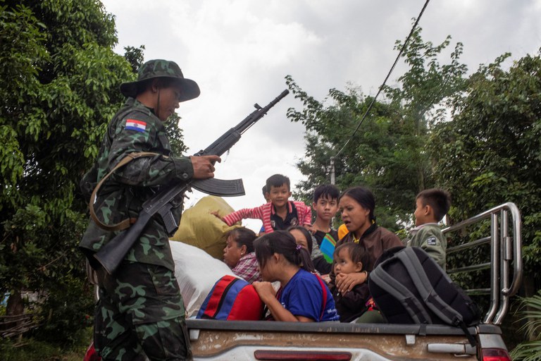 Seorang anggota pemberontak Pasukan Pertahanan Kebangsaan Karenni (KNDF) menyelamatkan warga sipil yang terjebak di tengah serangan udara selama pertempuran untuk mengambil alih Loikaw, di Negara Bagian Kayah, Myanmar, 14 November 2023. [Stringer/AFP]