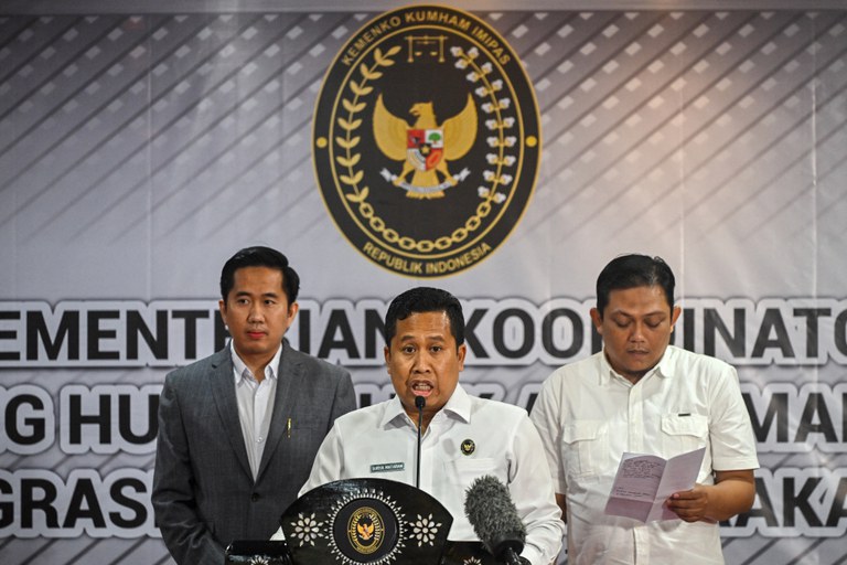 I Nyoman Gede Surya Mataram (tengah), pejabat senior di Kementerian Koordinator Hukum dan Hak Asasi Manusia,  dalam konferensi pers dengan wartawan terkait pemulangan Mary Jane Veloso, seorang Filipina yang dijatuhi hukuman mati karena narkoba, di Jakarta, 16 Desember 2024. [Juni Kriswanto/AFP]