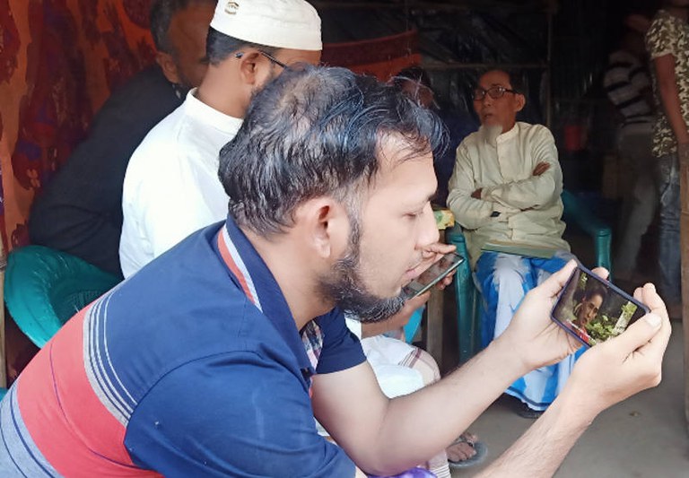 Seorang Rohingya di kamp pengungsi di Teknaf, Cox’s Bazar, Bangladesh, memeriksa ponselnya untuk mengetahui berita kudeta militer dan penangkapan Aung San Suu Kyi di Myanmar, 1 Februari 2021. [Abdur Rahman/BenarNews]