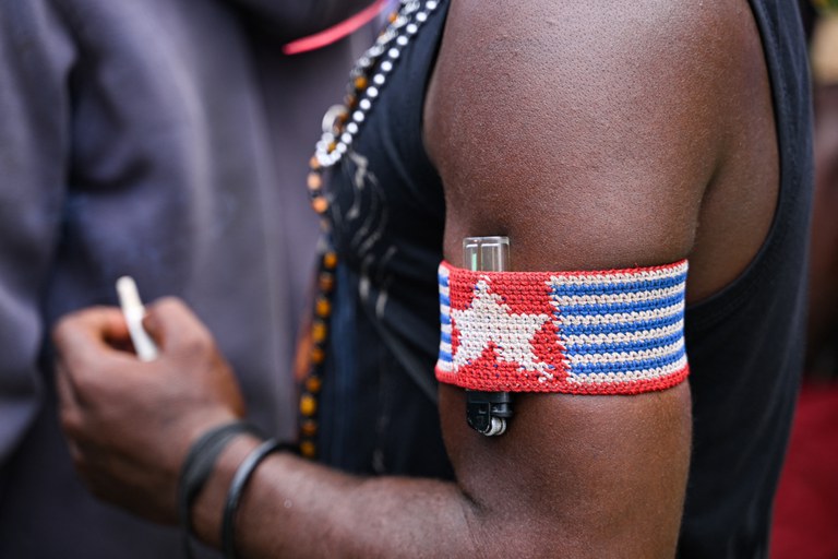 Seorang demonstrator asal Papua mengenakan gelang lengan bergambar bendera Bintang Kejora, simbol yang dilarang pemerintah karena melambangkan keluarnya Papua dari Indonesia dalam unjuk rasa menuntut penempatan tempat pemungutan suara (TPS) di desa mereka di Timika, Papua Tengah, pada 12 Februari 2024. [Adek Berry/AFP]